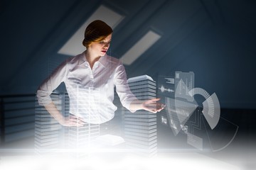 Poster - Composite image of redhead businesswoman using interactive desk