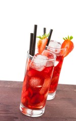 two glasses of strawberry cocktail with ice on white background