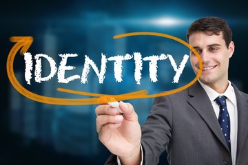 Poster - Businessman writing the word identity