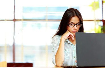 Portrait of busy businesswoman working at office