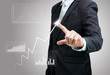 © sorapop - Businessman standing posture hand touch graph finance isolated