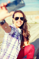 Sticker - smiling teenager taking picture with smartphone