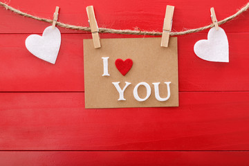 Wall Mural - I Love You message card over red wooden board