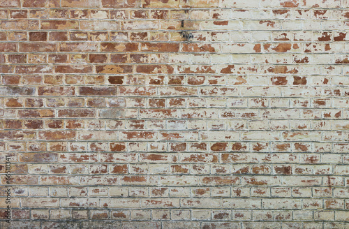 Fototapeta na wymiar Background of old vintage dirty brick wall with peeling plaster