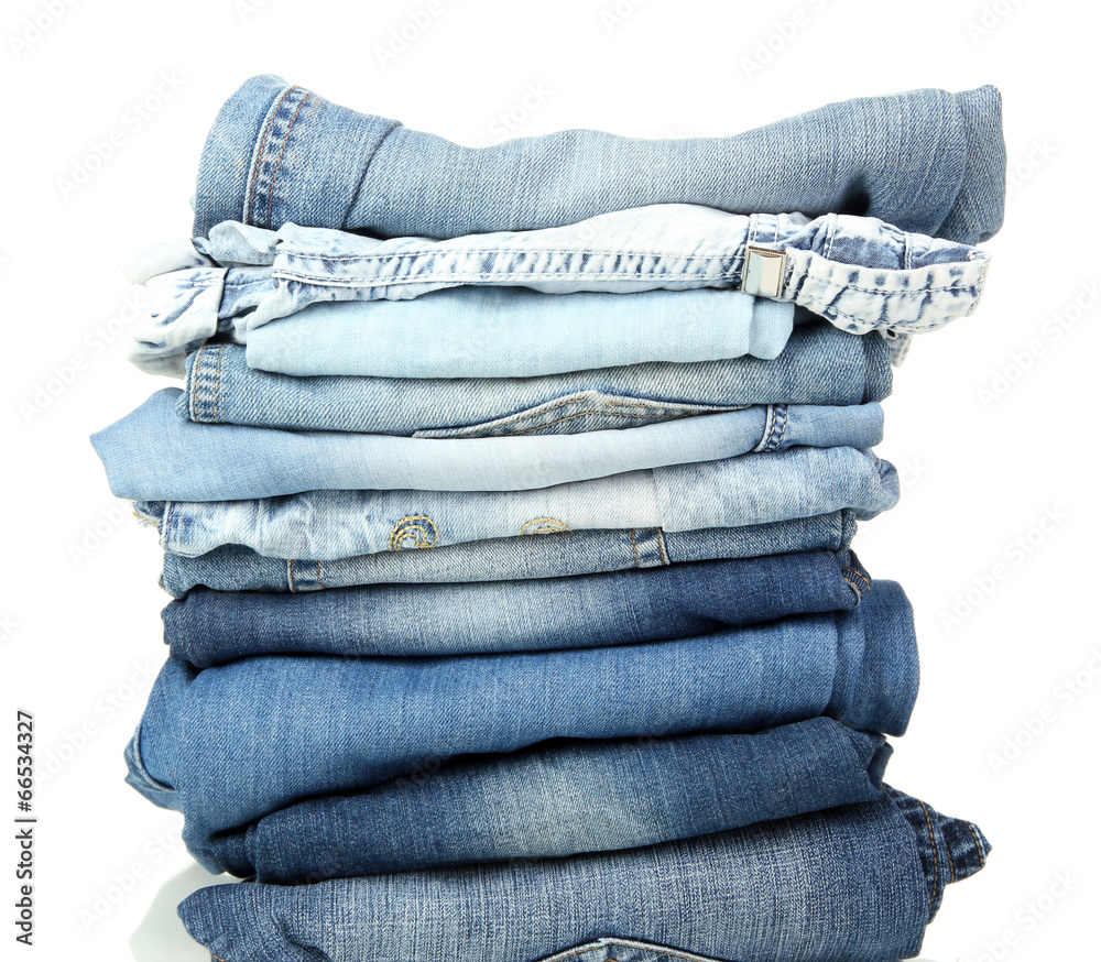 Lot of different blue jeans isolated on white