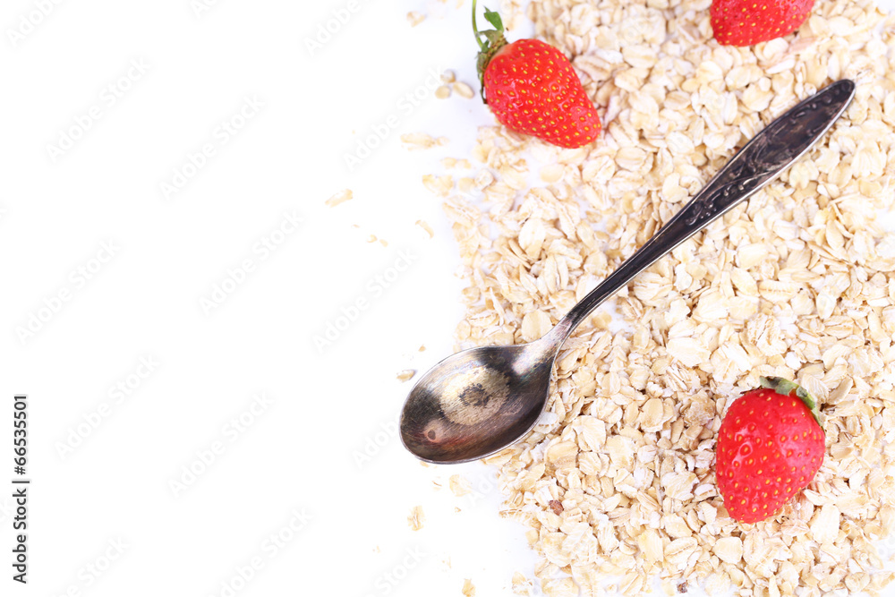 Strawberries with oatmeal and vintage spoon, isolated on white