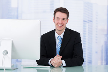 Poster - Businessman Using Computer At Office Desk