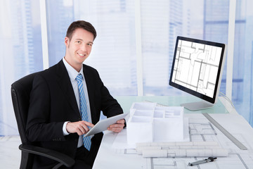 Poster - Architect Using Digital Tablet At Computer Desk
