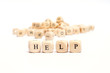 © puckillustrations - word with dice on white background- help