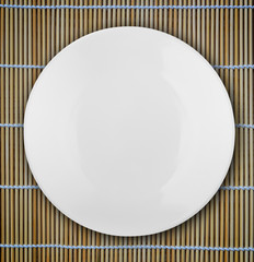 white empty bowl on a bamboo table