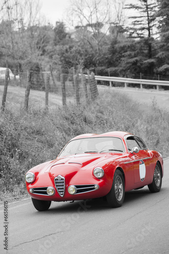 Fototapeta na wymiar Red vintage car on black and white background