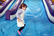 Little girl plays on Inflatable giant slide