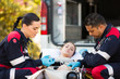 © michaeljung - paramedics giving unconscious young woman first aid