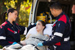 © michaeljung - paramedic team talking to young patient