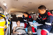 © michaeljung - paramedics talking to patient on ambulance