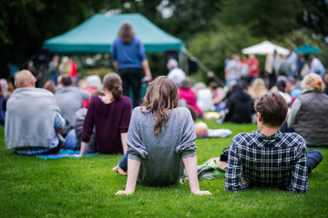 Friends enjoying an outdoors music community event, festival.