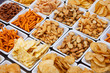 Many types of savoury snack in white dishes