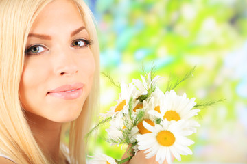 Poster - Young beautiful woman with flowers on bright background