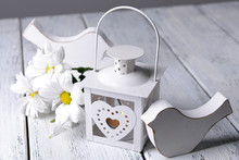 White Lantern With Flowers On Wooden Table, Close-up