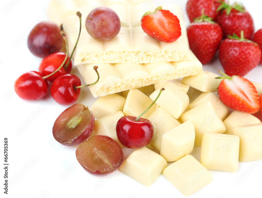 White chopped chocolate bar with fresh berries, isolated
