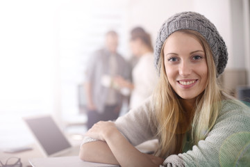 Trendy student girl sitting in class