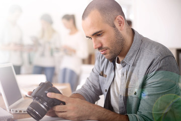 Wall Mural - Cheerful reporter working in office on laptop