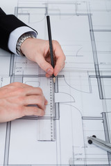 Poster - Businessman Working On Blueprint At Desk
