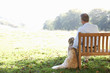 © Monkey Business - Senior man sitting outdoors with dog