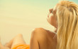 © vgstudio - Young happy beautiful woman lying on sea beach