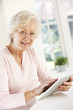 © Monkey Business - Senior woman using tablet at home