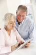 © Monkey Business - Senior couple using tablet at home