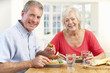 © Monkey Business - Retired couple enjoying meal at home