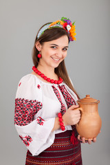 Wall Mural - Attractive woman wears Ukrainian is holding a jug national dress