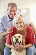 © Monkey Business - Retired couple at home with dog