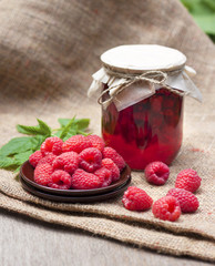 Poster - Raspberry preserve in glass jar and fresh raspberries on a plate