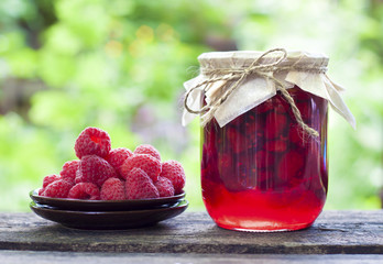 Canvas Print - Raspberry preserve in glass jar and fresh raspberries on a plate