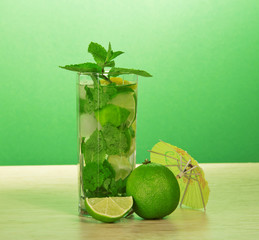 Mojito glass, an umbrella, mint and juicy lime