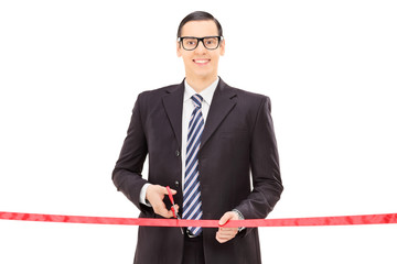 Wall Mural - Businessman cutting a red tape