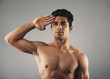 Strong muscular guy giving a salute