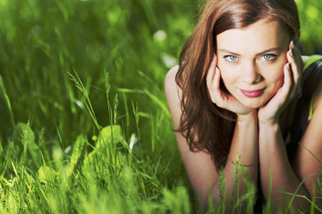 Woman laying in a green field