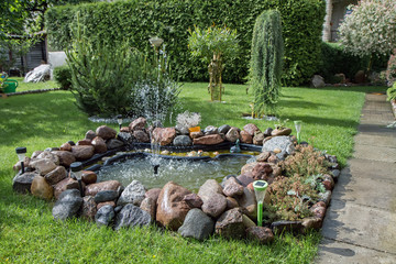 fountain in a beautiful garden with plants