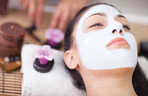 Fotografie, Obraz Spa therapy for young woman having facial mask at beauty salon