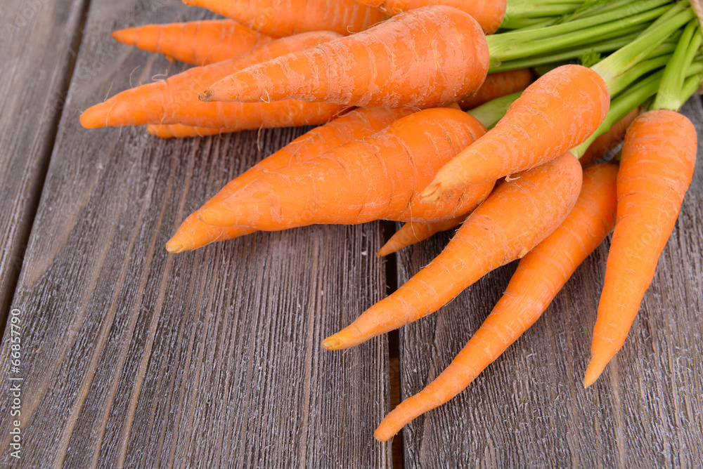 Fresh carrot on wooden background