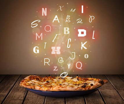 Fresh italian pizza with colorful letters on wood