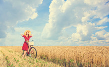 Redhead Peasant Girl With Bicycle On Wheat Field.