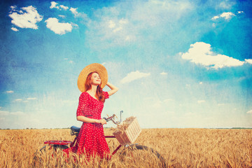 Sticker - Redhead peasant girl with bicycle on wheat field.