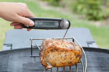 Wall Mural - Pork roast on the grill with thermometer