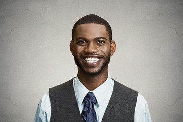 Portrait happy, smiling corporate executive grey wall background