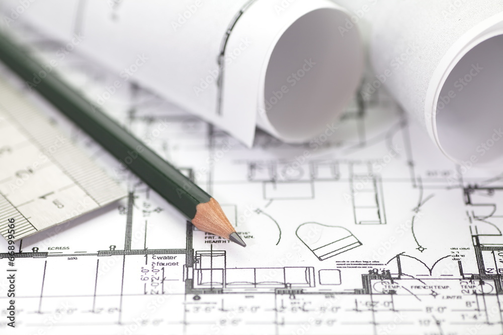 Architect rolls and plans construction project drawing