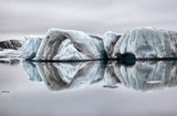 Fototapeta  - Floating ice symmetrically reflected in the water